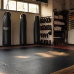 empty martial arts training studio with punching bags and equipment